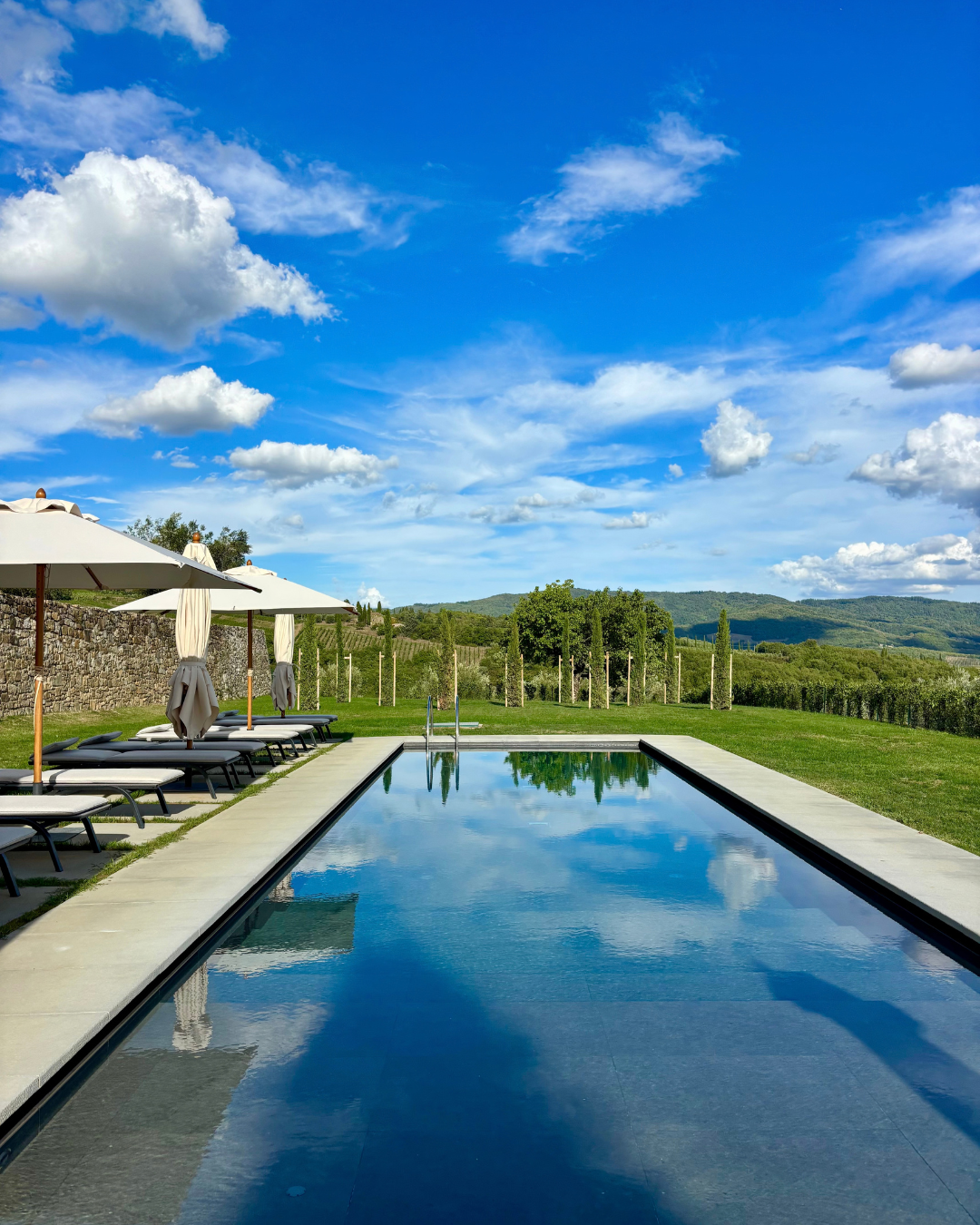 Quiet swimming pool reflecting the Tuscan sky